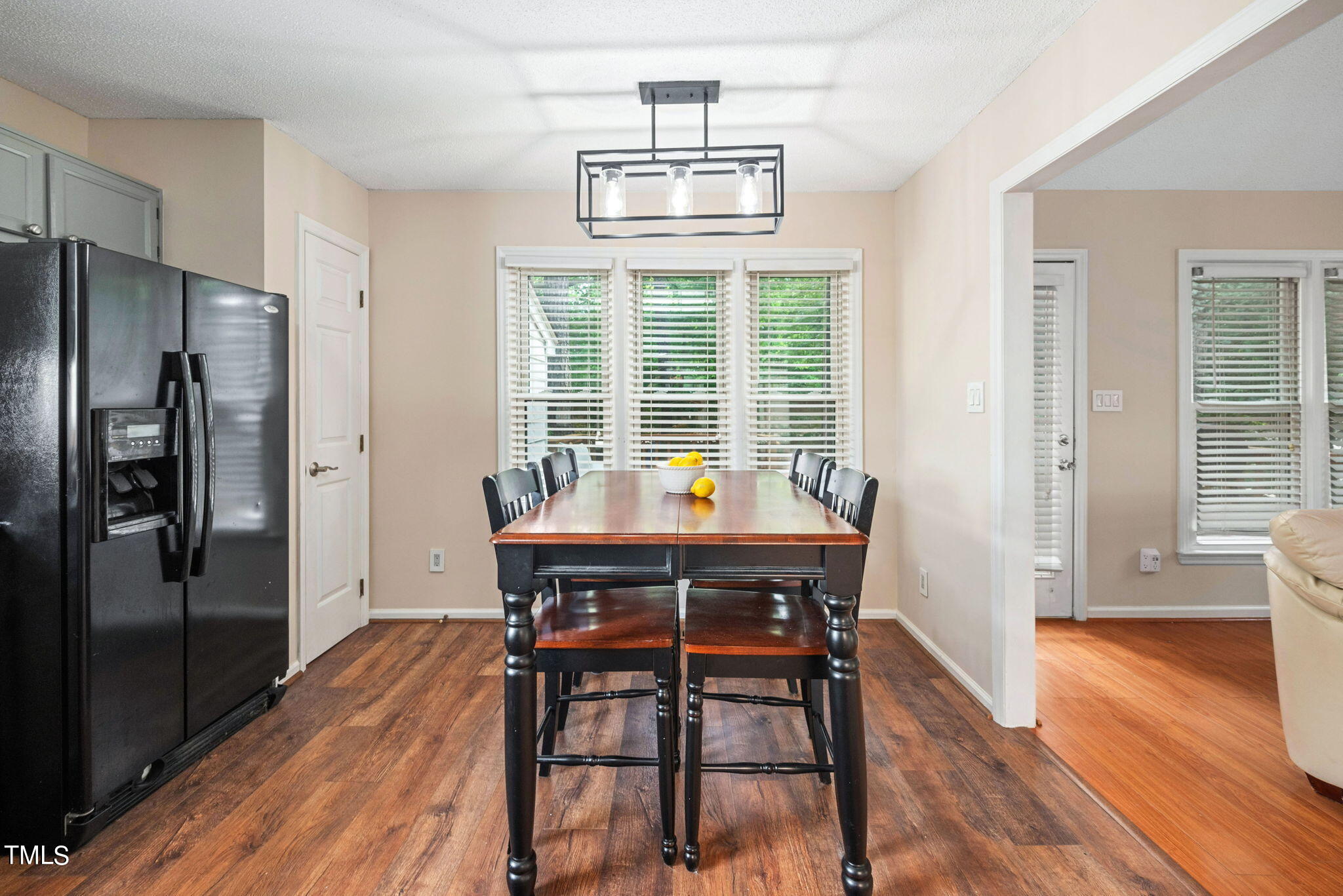4400 Emmit Drive Raleigh, NC 27604 - Photo 9 of 38 a view of a dining room with furniture a chandelier and wooden floor