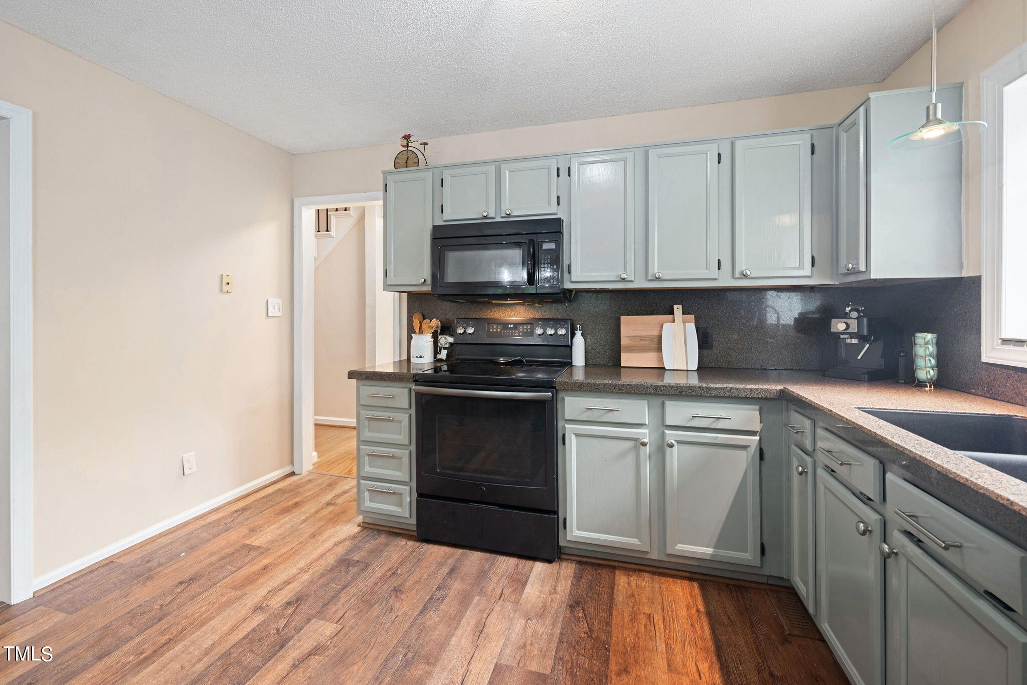 4400 Emmit Drive Raleigh, NC 27604 - Photo 10 of 38 a kitchen with granite countertop wooden cabinets and a stove top oven