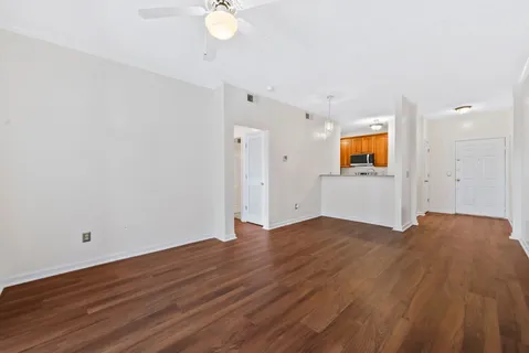 a view of a livingroom with wooden floor and cabinet