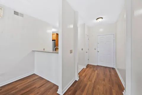 a view of a hallway with wooden floor