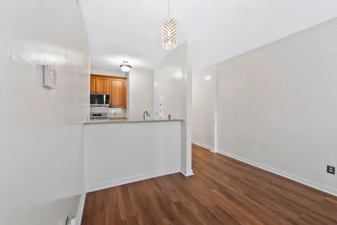 a view of a kitchen cabinets and wooden floor