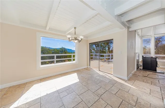 a view of kitchen with furniture and refrigerator