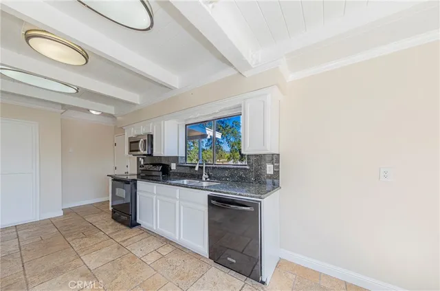 a kitchen with stainless steel appliances a refrigerator and a stove top oven