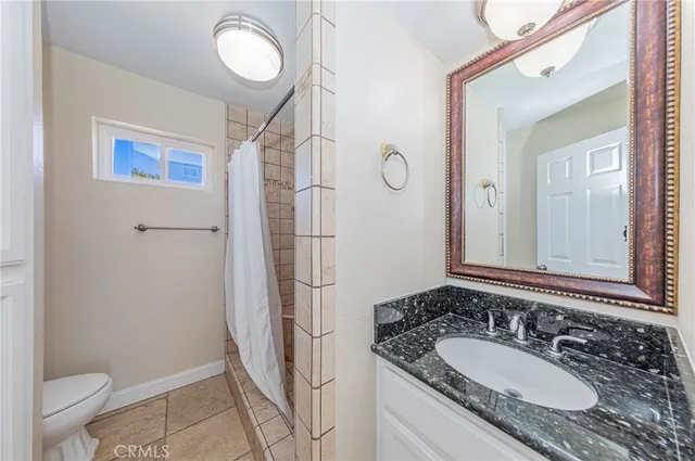 a view of a room with windows and chandelier fan