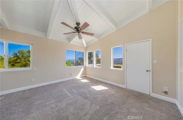 a kitchen with a refrigerator and a stove top oven