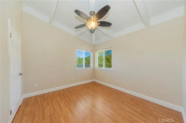 a spacious bedroom with a bed and cabinets