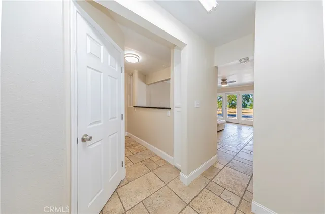 a view of a bedroom with a window and a chandelier