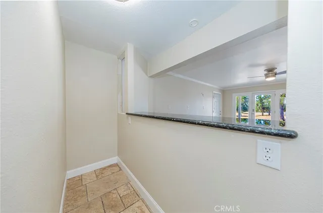 an empty room with a wooden shelves and mirrors