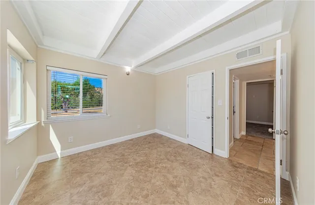 an empty room with windows and closet