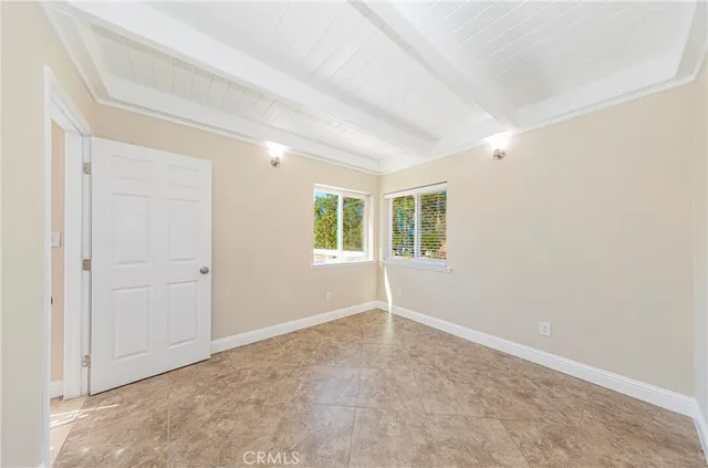 a view of an empty room with a kitchen