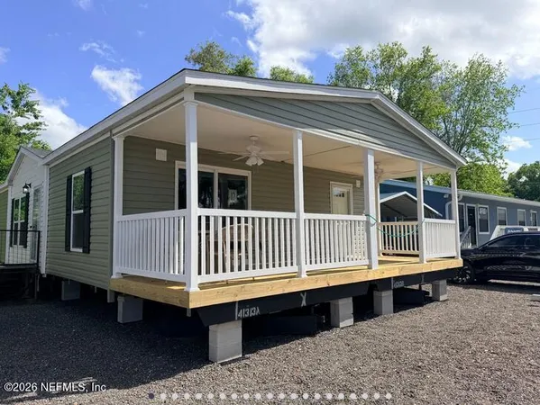 a porch with a bench next to a yard
