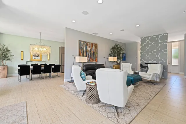 a living room with furniture a wooden floor and a large mirror