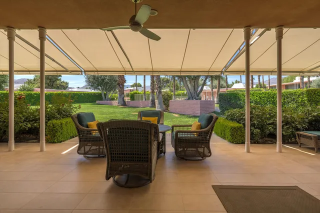 a view of a swimming pool with a chair and couches in the patio