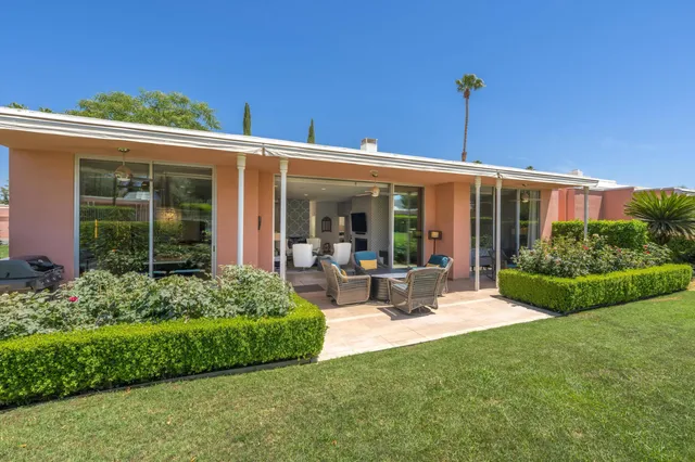 a wooden bench with trees in the background