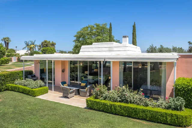 a view of a house with sitting area and garden