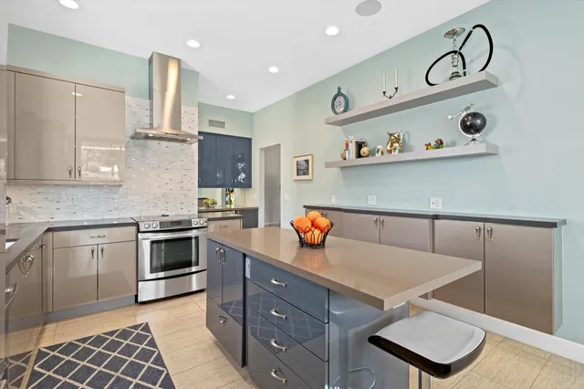 a kitchen with stainless steel appliances granite countertop a sink stove and cabinets