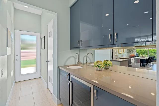 a kitchen with stainless steel appliances granite countertop a sink and a refrigerator
