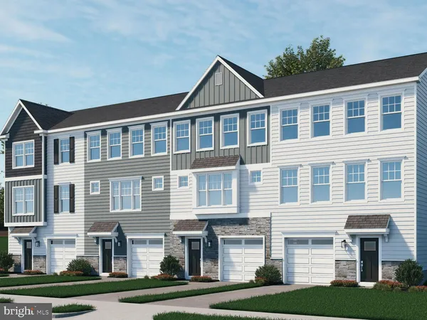 a front view of a residential apartment building with a yard