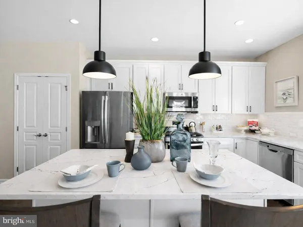 a kitchen with a sink kitchen island and stainless steel appliances