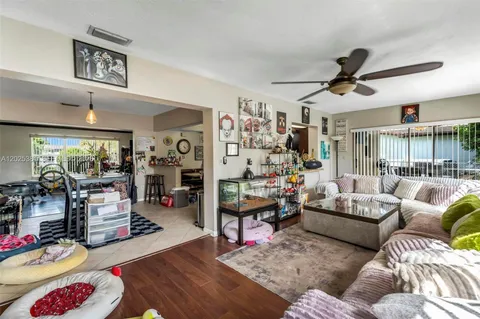 a living room with furniture and a ceiling fan