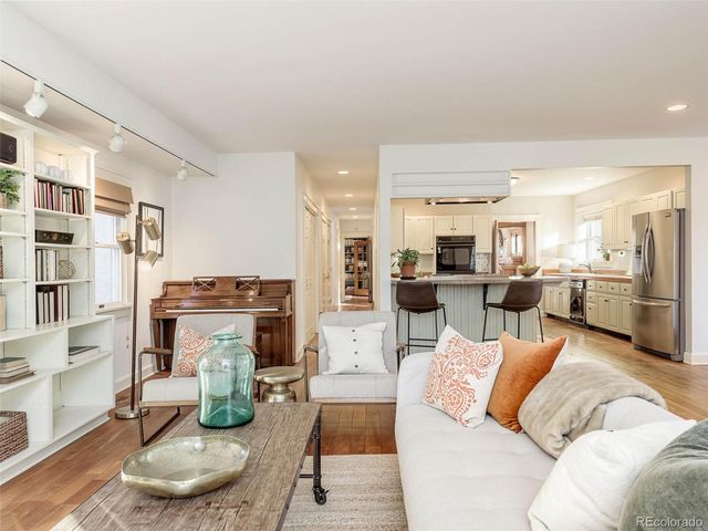 a living room with furniture kitchen and a table