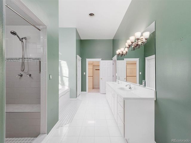 a en suite bathroom with a shower sink and mirror