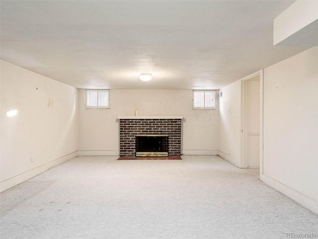 a view of empty room with a fireplace