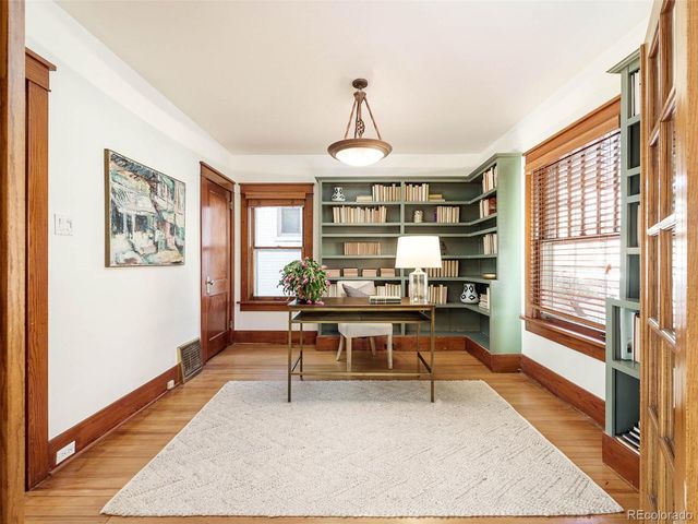 a view of a livingroom with furniture window and wooden floor