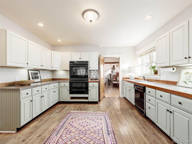 a kitchen with stainless steel appliances kitchen island granite countertop a refrigerator and cabinets