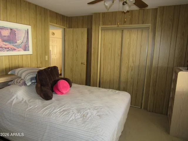 a bed room with a bed and a chair