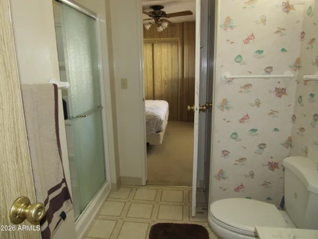 a bathroom with a toilet and a shower