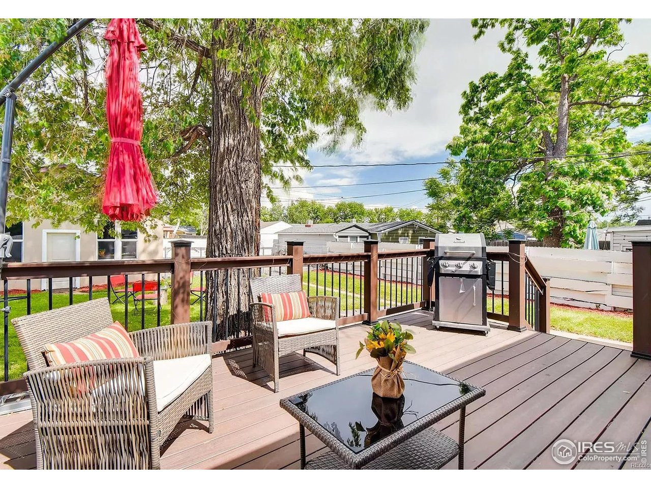 4870 Irving Street Denver, CO 80221 - Photo 18 of 19 a view of a deck with two chair and a potted plant
