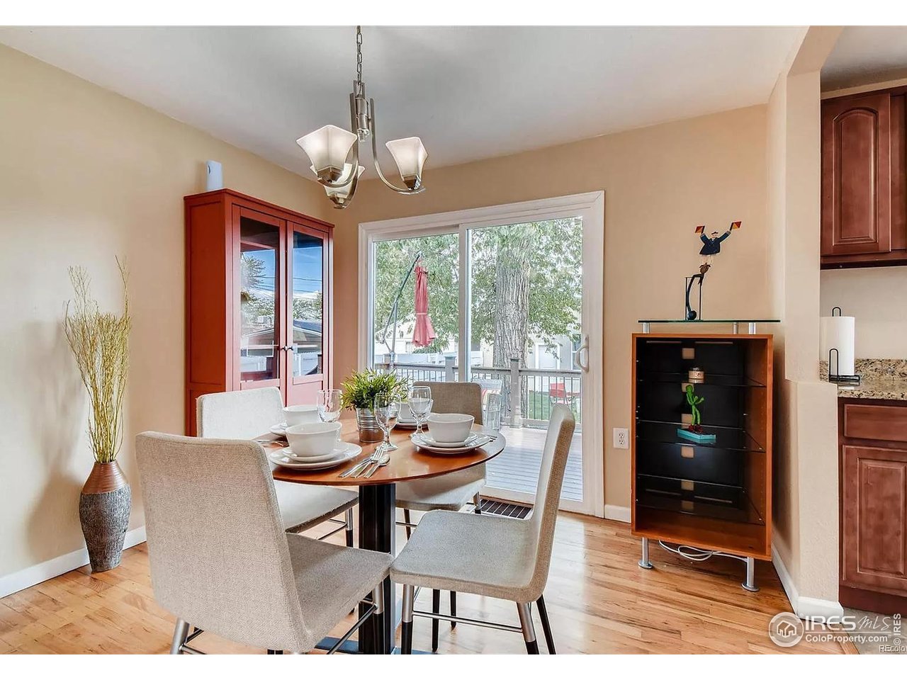 4870 Irving Street Denver, CO 80221 - Photo 5 of 19 a dining room with chandelier wooden floor and a chandelier