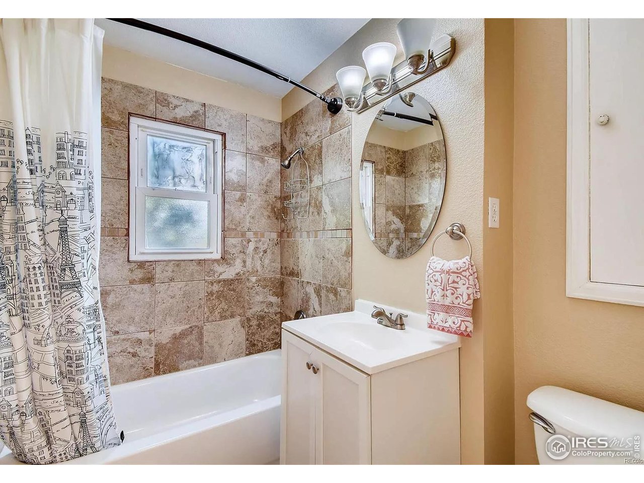 4870 Irving Street Denver, CO 80221 - Photo 10 of 19 a bathroom with a sink a bathtub and a mirror