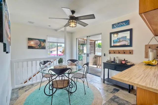 a dining room with furniture a chandelier and wooden floor