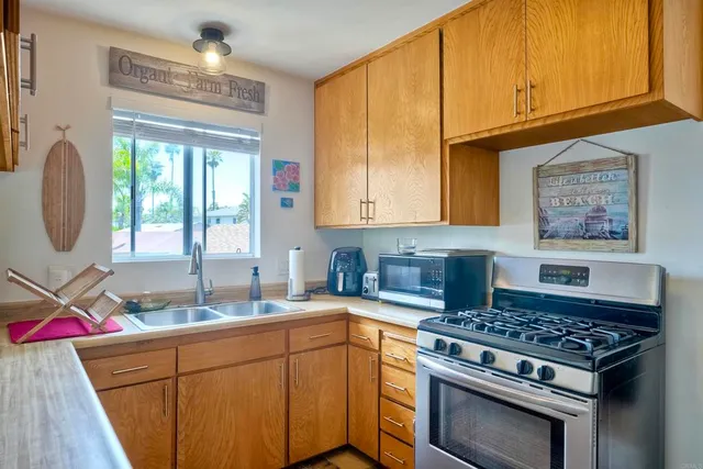 a kitchen with a stove a sink and a microwave