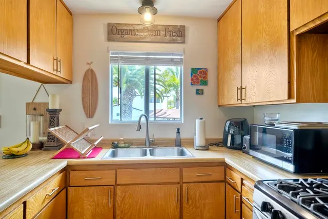 a kitchen with a sink appliances and cabinets