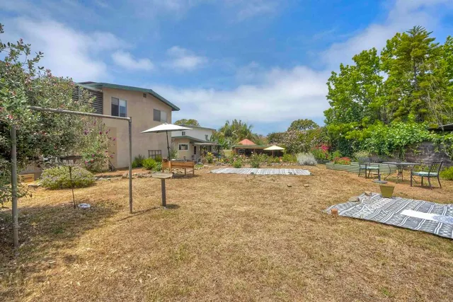 a front view of house with yard and trees around