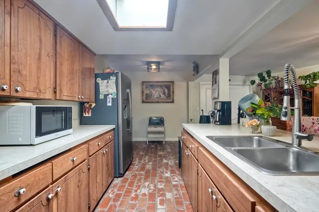 a kitchen with stainless steel appliances granite countertop a sink stove and cabinets