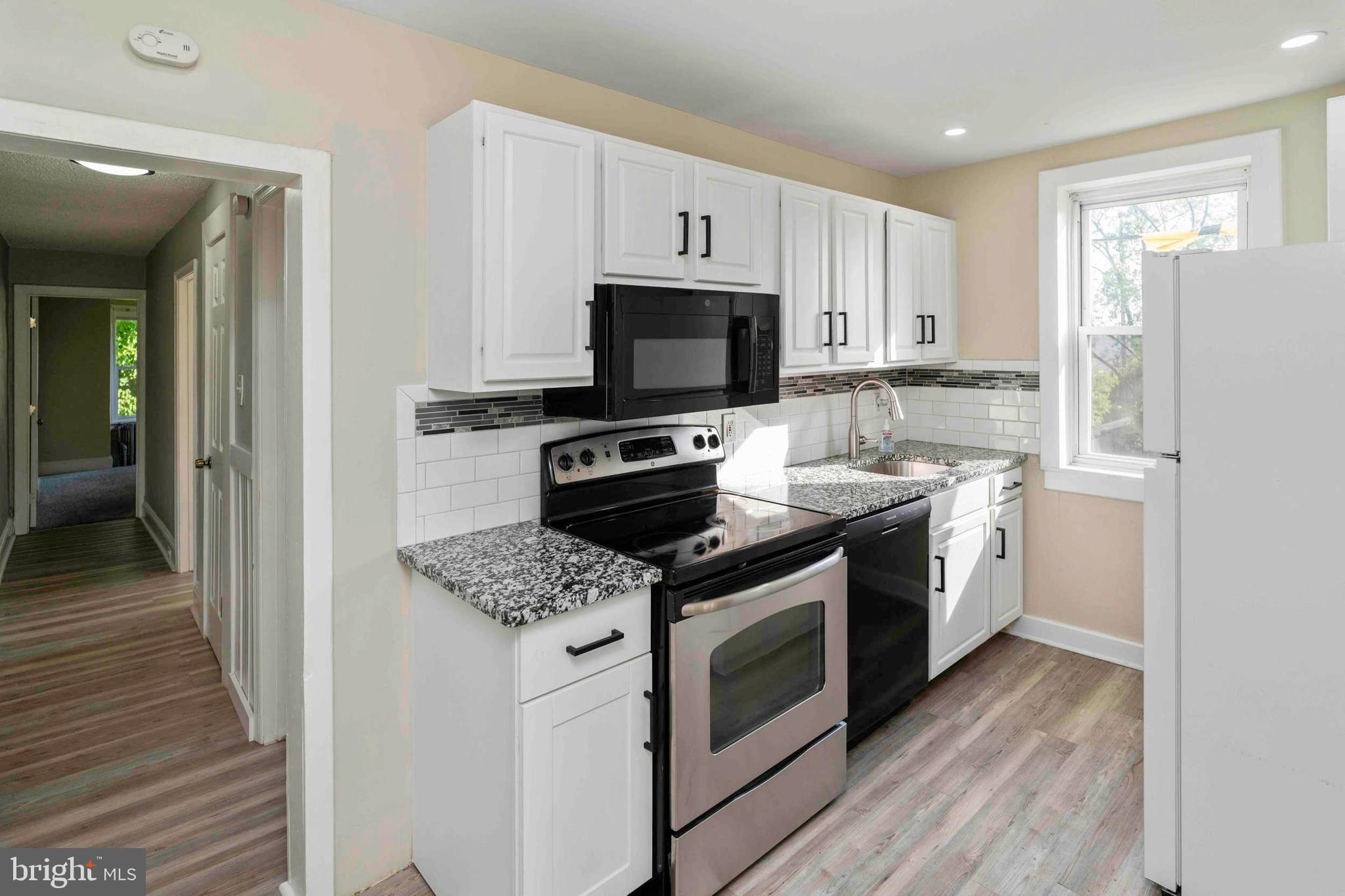 132 West Ridge Road Marcus Hook, PA 19061 - Photo 16 of 26 a kitchen with a stove top oven and refrigerator