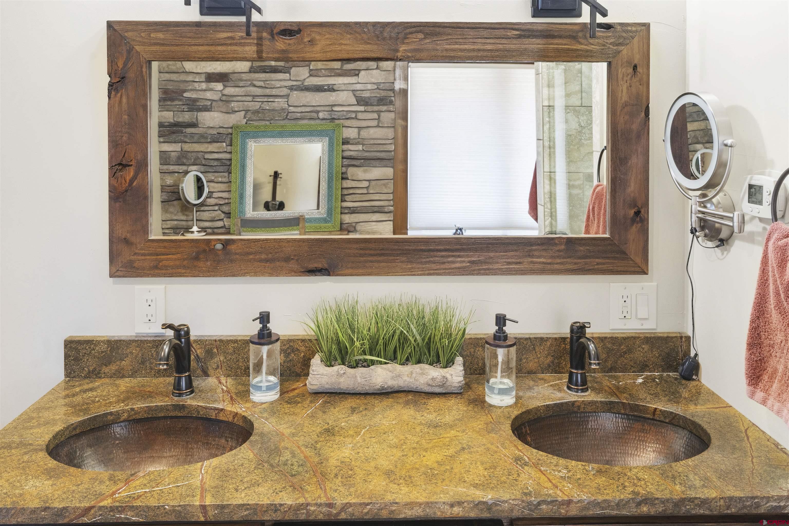 684 Falcon Way Montrose, CO 81403 - Photo 15 of 43 a bathroom with sink granite and a mirror