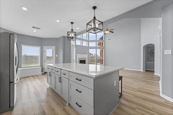 a kitchen with granite countertop white cabinets and white appliances