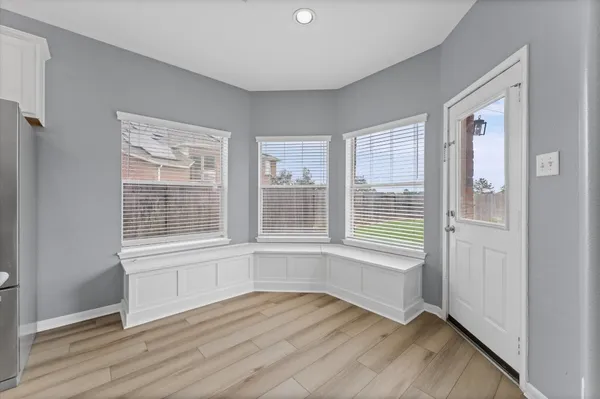 a living room with stainless steel appliances kitchen island wooden floors and view living room