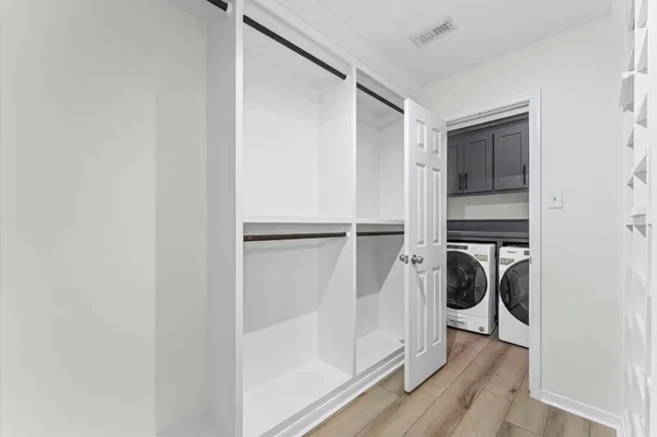 a view of a kitchen with a white cabinet and wooden floor