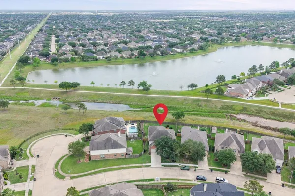 an aerial view of a house with a garden and lake view