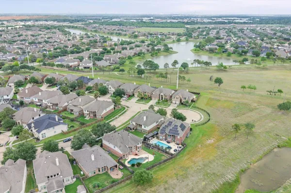 an aerial view of residential building with outdoor space and river