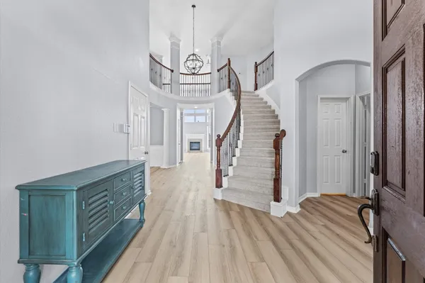 a view of entryway and hall with wooden floor