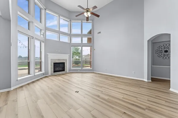 a kitchen with kitchen island stainless steel appliances a table chairs refrigerator and microwave