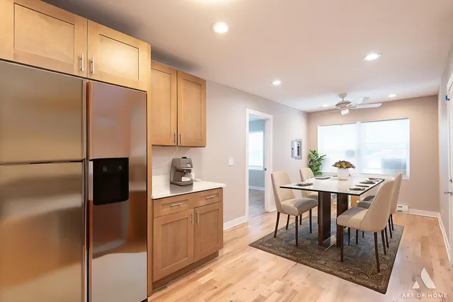 an empty room with wooden floor a ceiling fan and windows