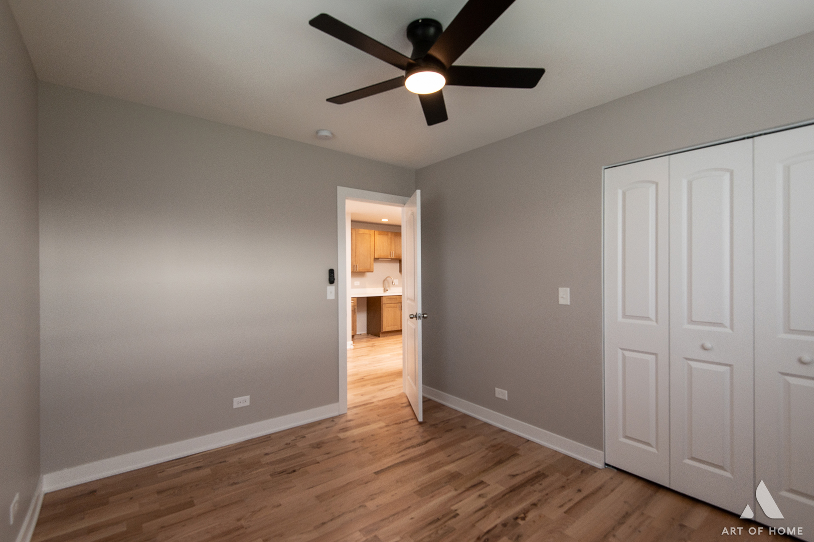 14924 Indiana Avenue Dolton, IL 60419 - Photo 25 of 73 an empty room with wooden floor a ceiling fan and windows